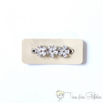 Beautiful light beige imitation leather patch with three zirconia flowers set in pavé