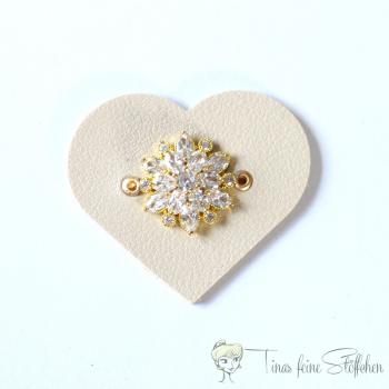 Beautiful heart-shaped light beige leatherette patch with golden flower with 19 zirkonia in pavé