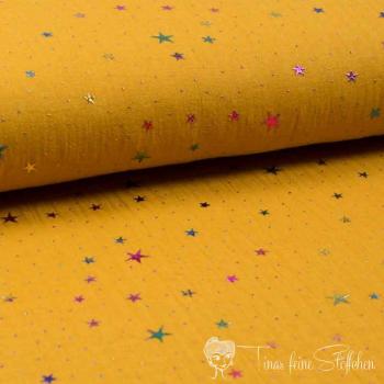 0,5 meter Muslin ochre with foilprint colorful stars