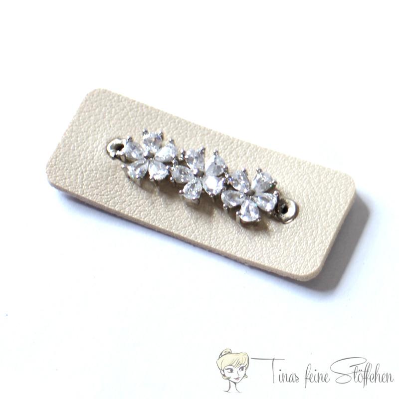 Beautiful light beige imitation leather patch with three zirconia flowers set in pavé